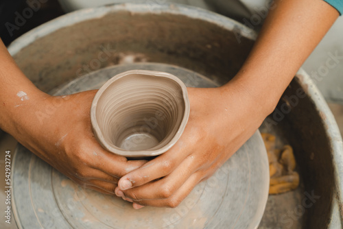 happy smiling girl having fun to learning and work with craft art of clay hand-made workshop in ceramic studio, little ceramist enjoy in creative handcraft hobby with pottery artisan school class photo