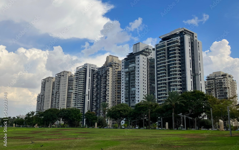 Residential area street, palm trees, tall new buildings, modern apartment buildings in Israel Residential area street, palm trees, tall new buildings, modern apartment buildings in Israel