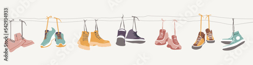 Collection of shoes hanging on shoelaces. photo