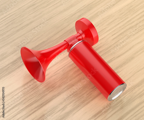 Red portable air horn on wooden table photo