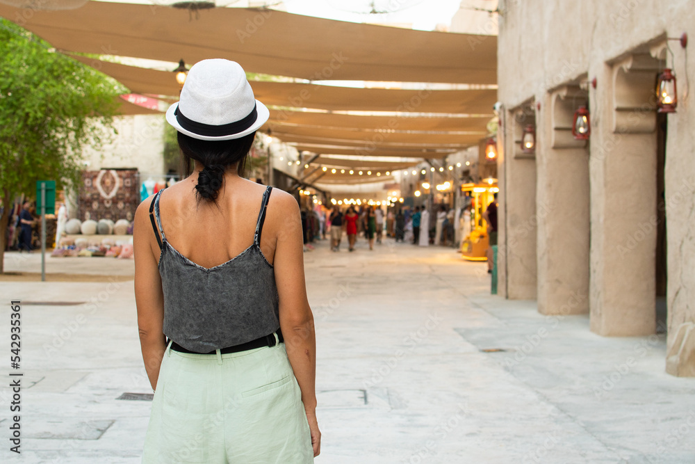 Fototapeta premium Dubai, UAE - 12th october, 2022: woman tourist walk on old Dubai explore area and souvenir shops