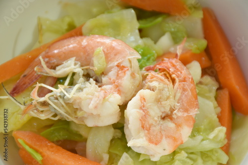 fried slice cabbage and carrot with shrimp in soy sauce on bowl 