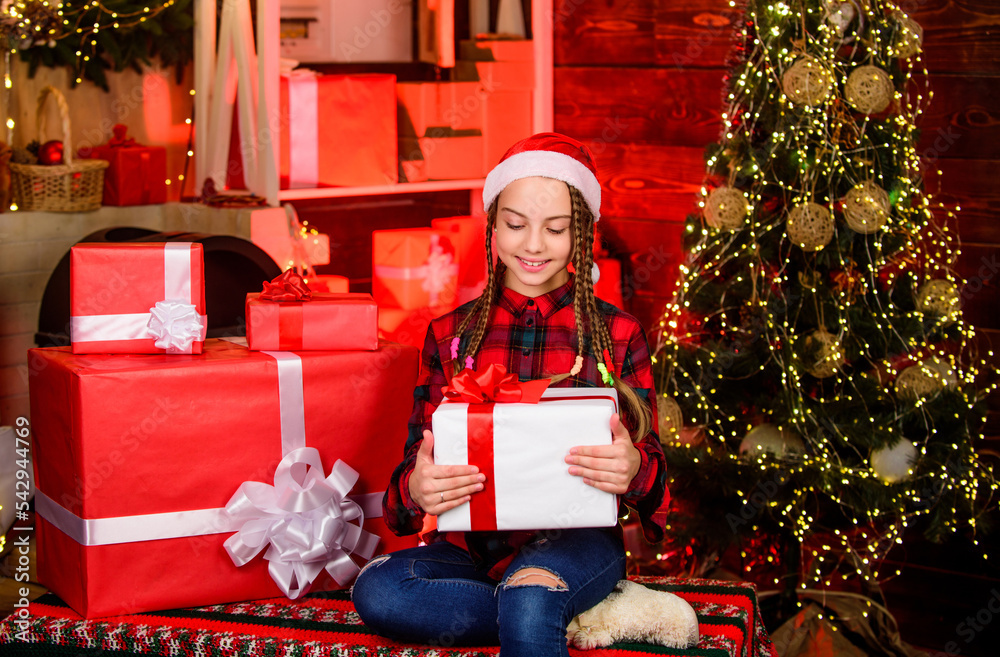 Small cute girl with gift box near christmas tree. Winter present. Present concept. Child enjoy celebration new year present. Season to giving presents for loved ones. Spread love. Kindness concept