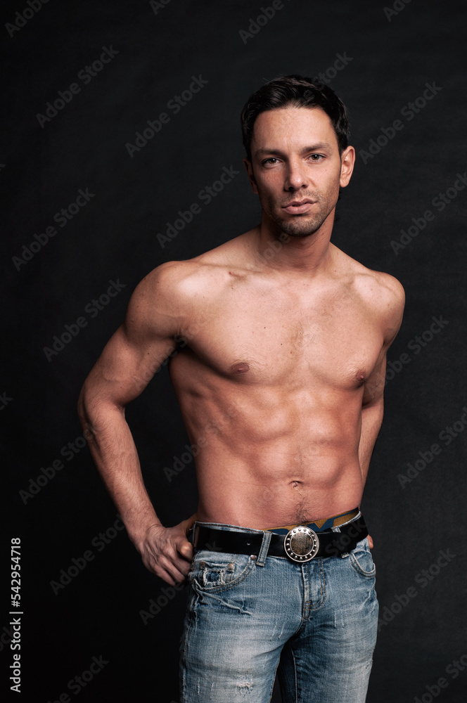 Fototapeta premium Young attractive guy posing in the studio. Beautiful body.