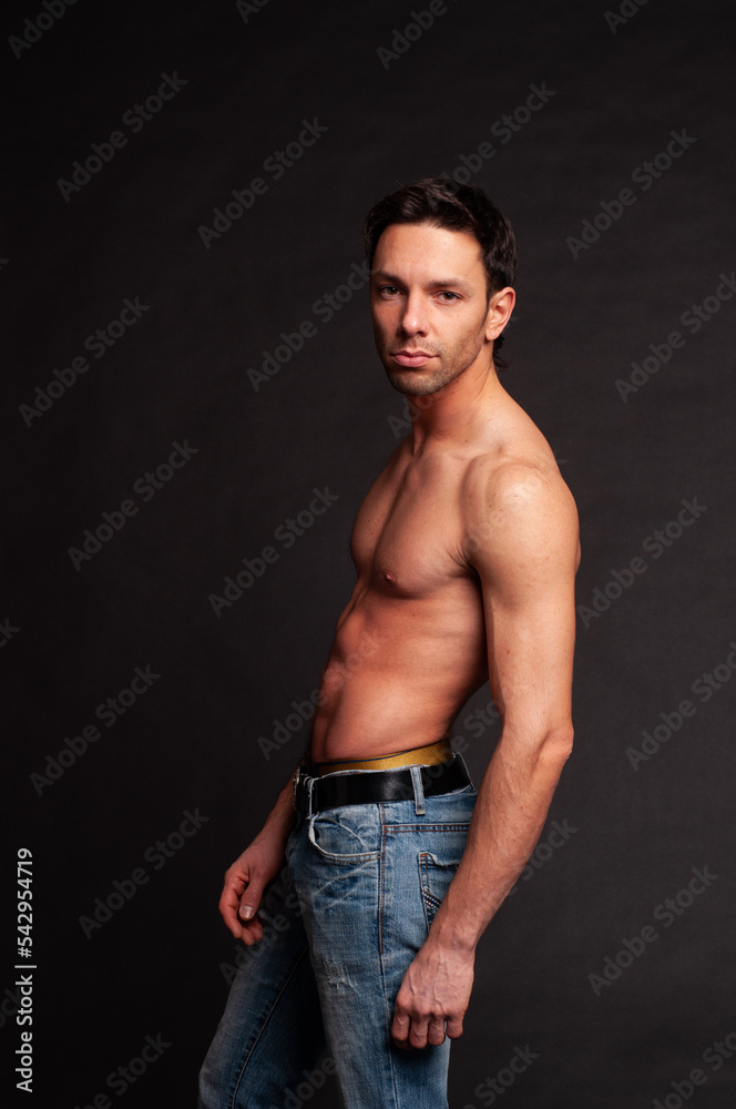 Young attractive guy posing in the studio. Beautiful body. Young attractive guy posing in the studio. Beautiful body.