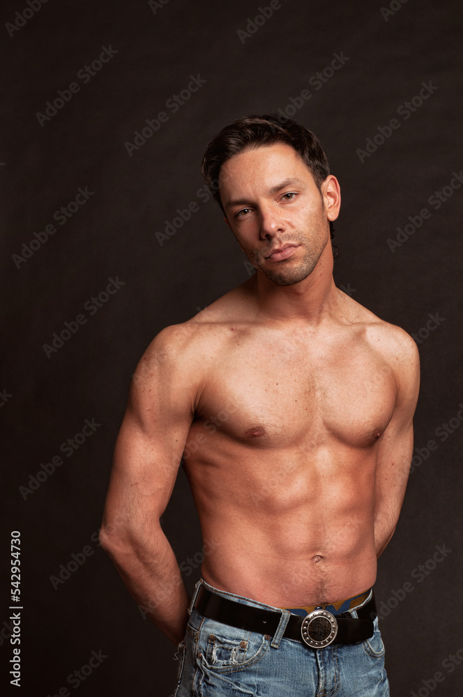 Fototapeta premium Young attractive guy posing in the studio. Beautiful body.