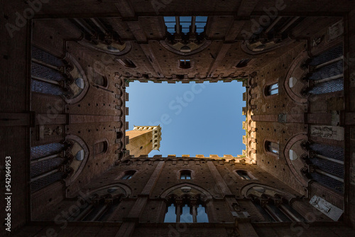 Fototapeta Siena, Italy – may, 2022: view of sky from internal court in Palazzo Pubblico Siena, Italy