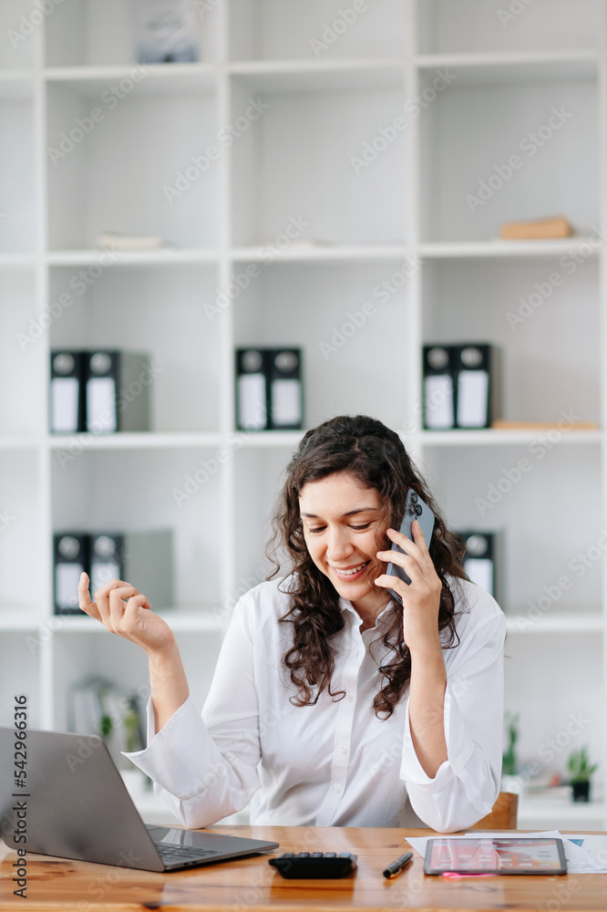 Happy business woman have the joy of talking on the smartphone, tablet and laptopon the office Happy business woman have the joy of talking on the smartphone, tablet and laptopon the office