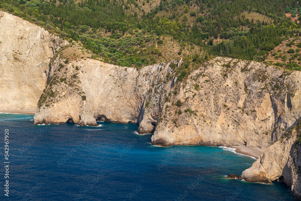 Top close up view at Assos peninsula cliffs and blue Ionian Sea water. Aerial view, summer scenery of famous travel destination in Cephalonia, Greece, Europe