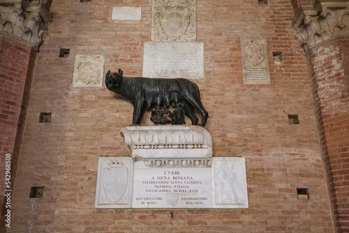 View of She-wolf of Siena (Lupa Senese) with Senio and Ascanio, sons of Remo, founders of the city. Marble statue, symbol of the city of Siena photo