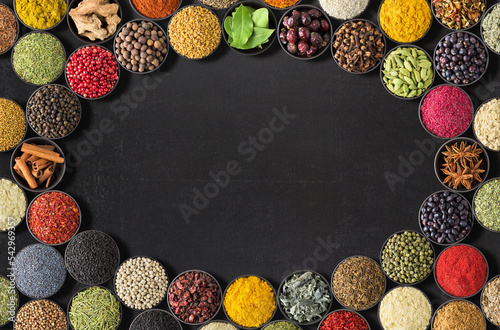 Fototapeta Naklejka Na Ścianę i Meble -  Indian spices and herbs on  black table. background of spices with empty space for text or label