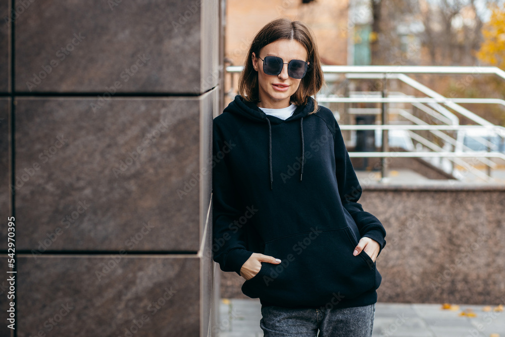 Young woman in glasses and black hoodie Young woman in glasses and black hoodie