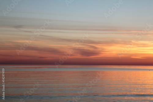 Sunsetting sky above calm sea during the dusk. Selective focus