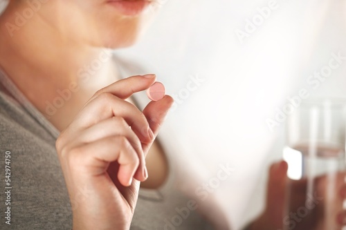 Healthy medical vitamins concept, woman hold a pill