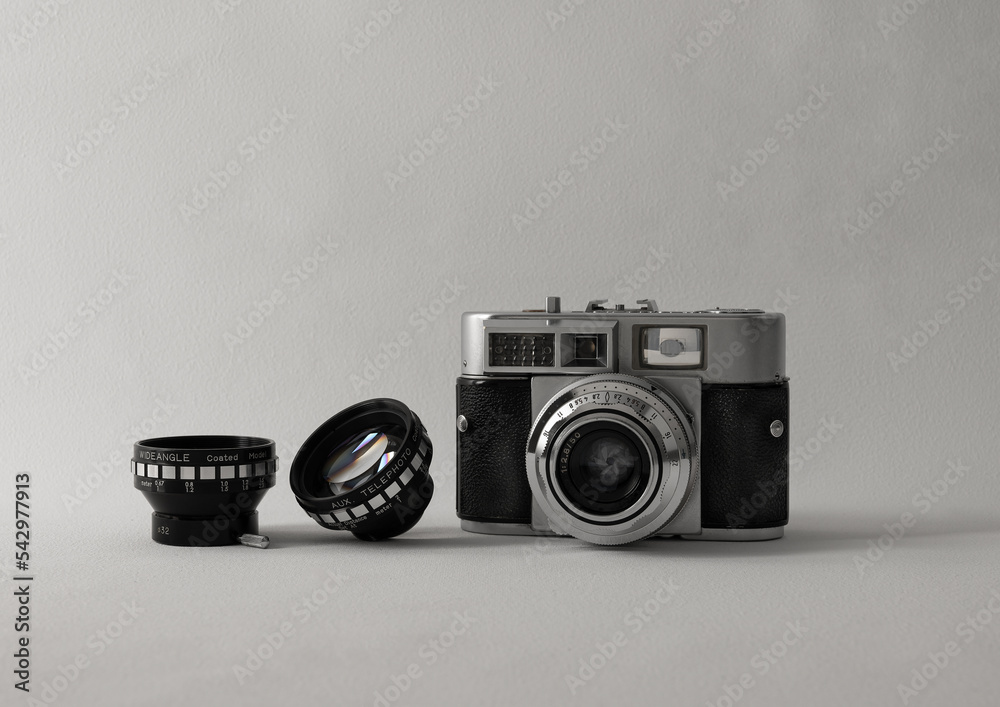 old photo camera with photo lenses on white background
