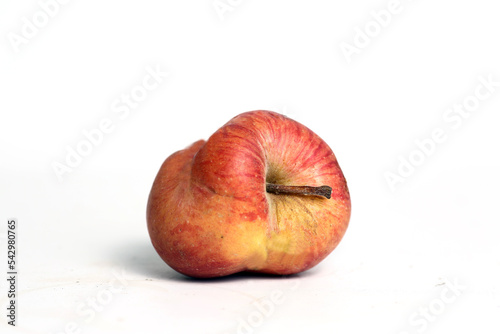 Concept of ugly food - red apple on white background