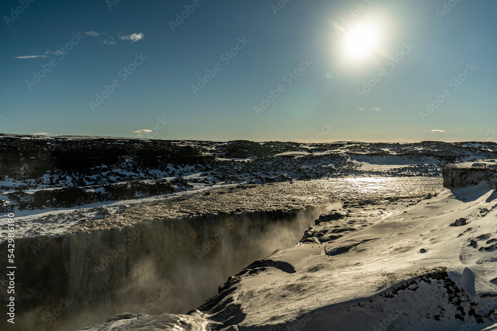 dettifoss waterfall in iceland with liffs covered with snow