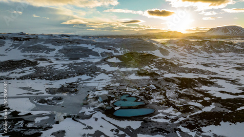 aerial view of Myvatn Nature Baths hot spring with landscape covered with snow during sunrise photo
