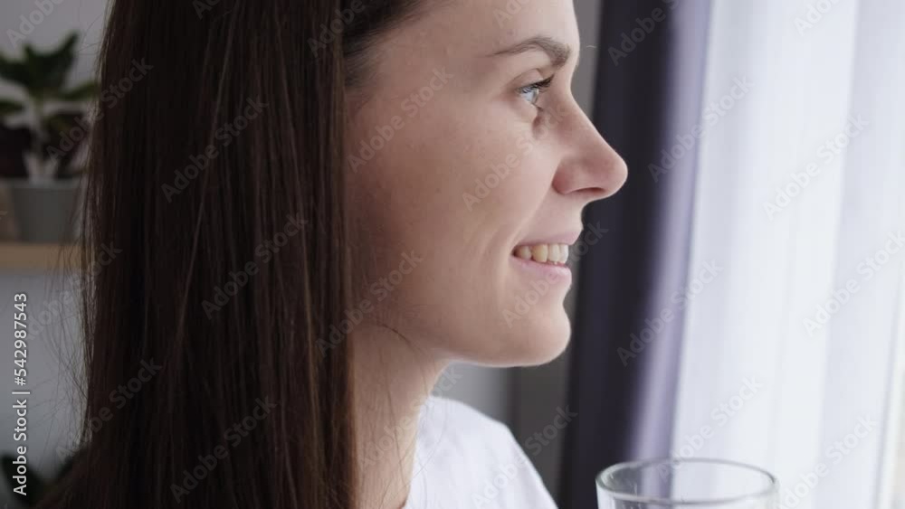 Happy attractive woman hydrating thirst keep diet nutrition weight loss health care natural balance concept. Healthy young female holding glass drinking fresh transparent pure filtered mineral water Happy attractive woman hydrating thirst keep diet nutrition weight loss health care natural balance concept. Healthy young female holding glass drinking fresh transparent pure filtered mineral water