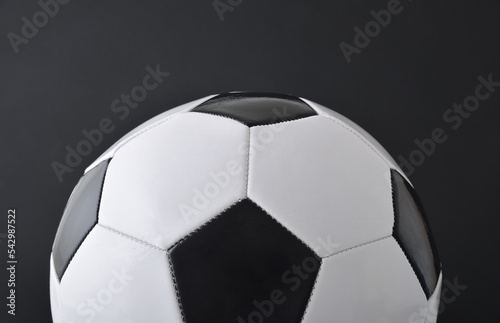 Detail of half soccer ball isolated on black background.