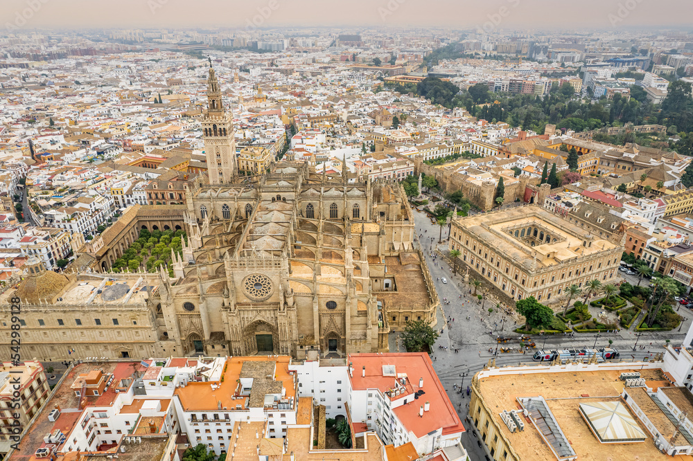 Fototapeta premium The drone aerial view of Seville Cathedral (Catedral de Santa Maria de la Sede de Sevilla) at sunrise, Seville, Spain.