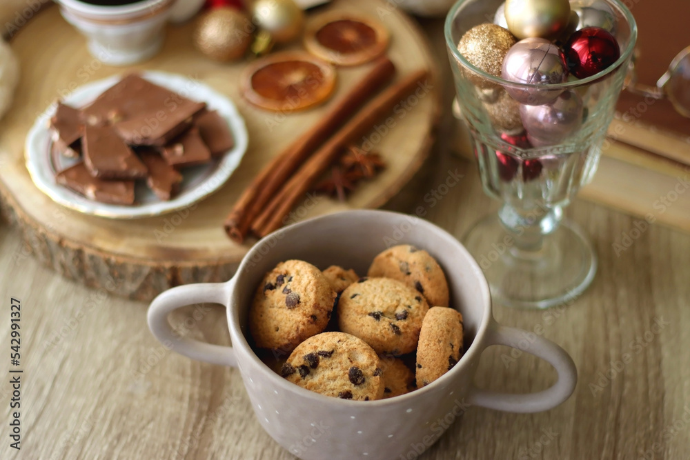 Cup of tea or coffee, various sweets and spices, Christmas decorations, comfy blanket, books and glasses. Selective focus. Cup of tea or coffee, various sweets and spices, Christmas decorations, comfy blanket, books and glasses. Selective focus.