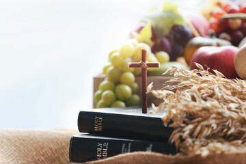 Church Thanksgiving Day bountiful fruit decoration and background with bible and jesus cross

