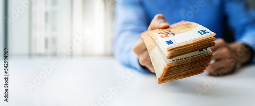 hand gives euro money banknotes. bank credit, cash loan or prize concept. banner with copy space