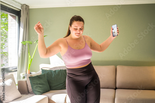 Positive caucasian woman with excess weight smiling happily and having fun