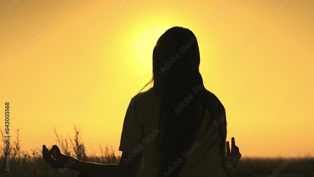 yoga hand sign. girl sunset doing yoga. female meditation glare sun. yoga stretching exercise. concentration outdoors concept. weight loss healthy lifestyle. fingers hand. hand gesture sunset. sport.
