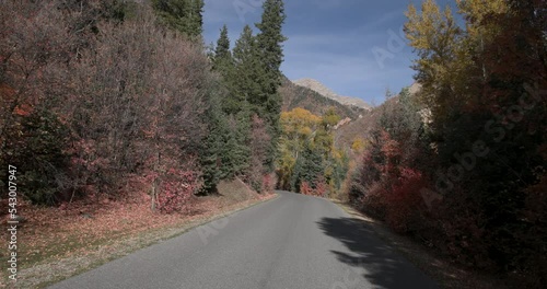 Beautiful autumn mountain canyon Utah POV 2 4K. Beautiful autumn fall colors along Wasatch Mountains. Rural farming community dirt road through hills to canyon. photo