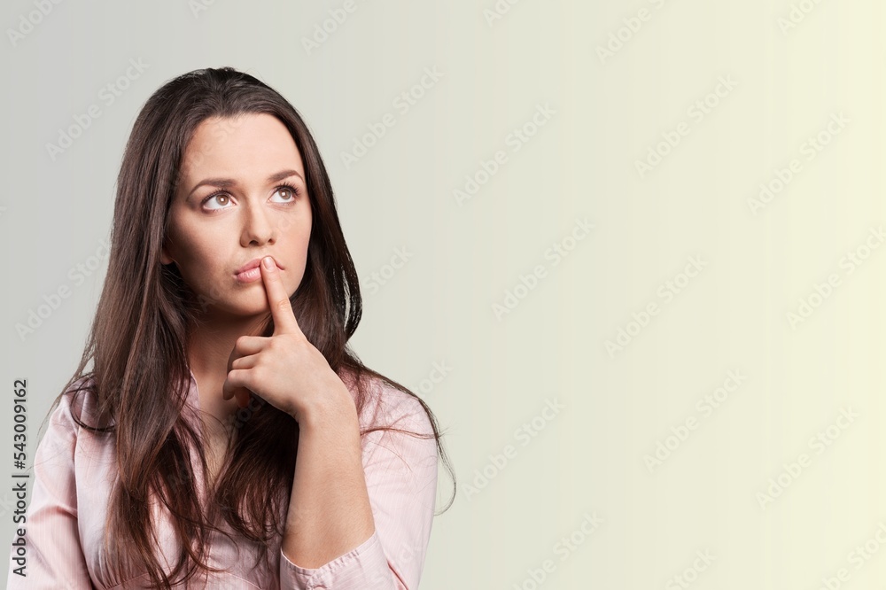 Young woman thinking and posing on background. Young woman thinking and posing on background.