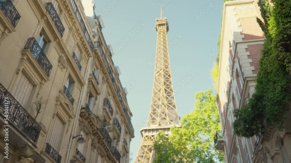 Young woman looking at the Eiffel Tower on a famous street Young woman looking at the Eiffel Tower on a famous street