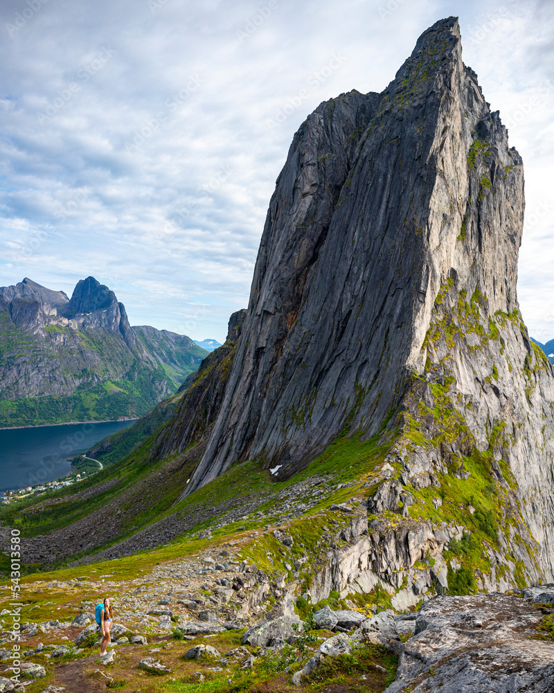 backpacker girl hiking on hesten overlooking Norway’s famous segla