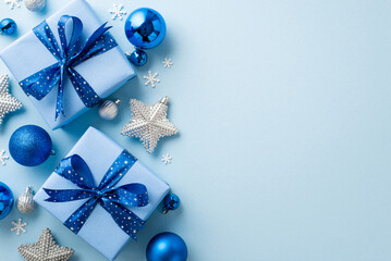 New Year concept. Top view photo of big gift boxes with ribbon bows blue and silver baubles sparkle star ornaments and snowflake shaped confetti on isolated pastel blue background with blank space