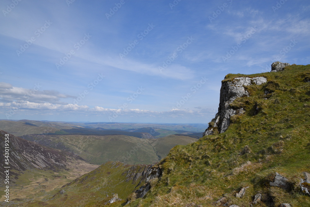 a view looing down in the crater of Cadair Idris with a mountain view behind it a view looing down in the crater of Cadair Idris with a mountain view behind it