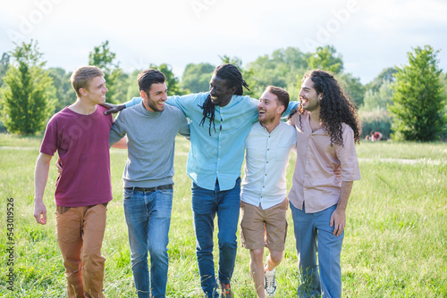Group of young friends having a fun time together in the park outdoors