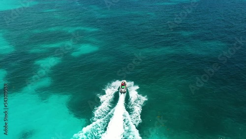 Aerial view of Jet ski rushes through the waves of the Caribbean Sea. 