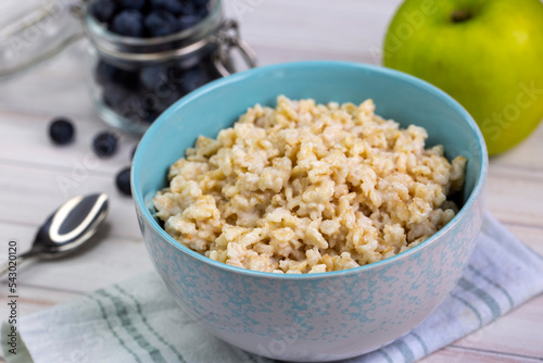Healthy breakfast oatmeal porridge in bowl. Hot mashed oats, vegan vegetarian weight loss diet breakfast food