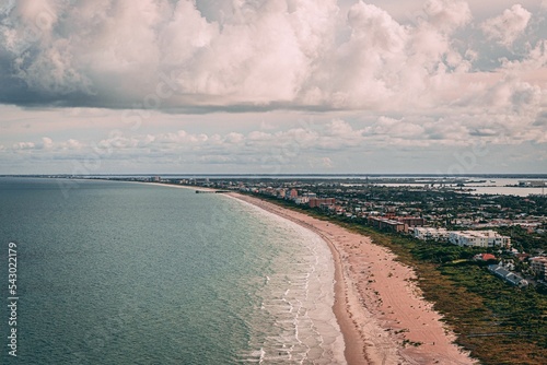 Drone shot of Cape Canaveral cityscape by the beach under cloudy sky in Florida photo