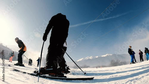Kabinkov ski lift cable car cabins at winter resort Bansko. People take ski lessons from instructor, slow motion photo
