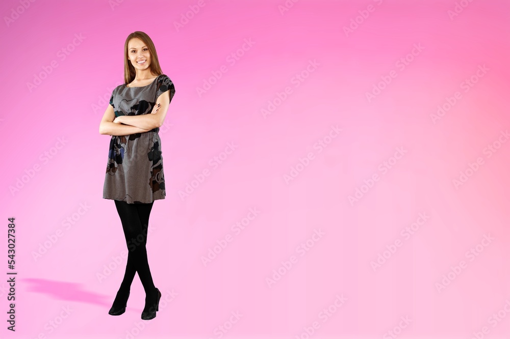 Happy young woman in beautiful dress posing