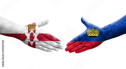 Handshake between Liechtenstein and Northern Ireland flags painted on hands, isolated transparent image. photo