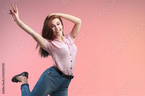 Fototapeta Naklejka Na Ścianę i Meble -  Happy fashion young woman dance and posing