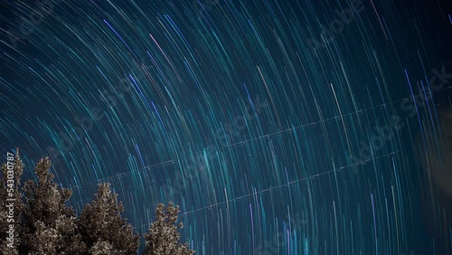 Stars move around a polar star. Time-lapse of Star trails in the night sky. 4K
