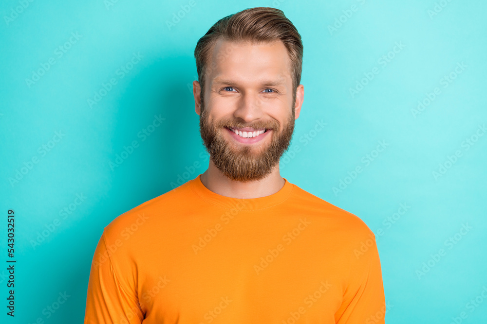 Photo portrait of attractive young guy toothy beaming smiling dressed stylish orange clothes isolated on aquamarine color background Photo portrait of attractive young guy toothy beaming smiling dressed stylish orange clothes isolated on aquamarine color background