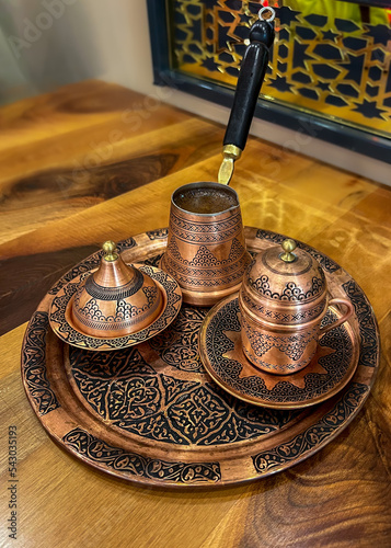 Turkish coffee, copper cezve, authentic arabic  coffee utensil set, coffee pot on wooden table photo