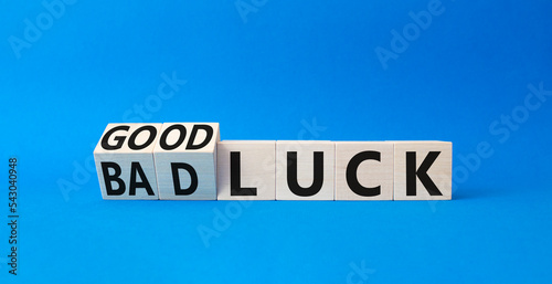 Good Luck and bad Luck symbol. Turned wooden cubes with words Bad Luck and Good Luck. Beautiful blue background. Business concept. Copy space