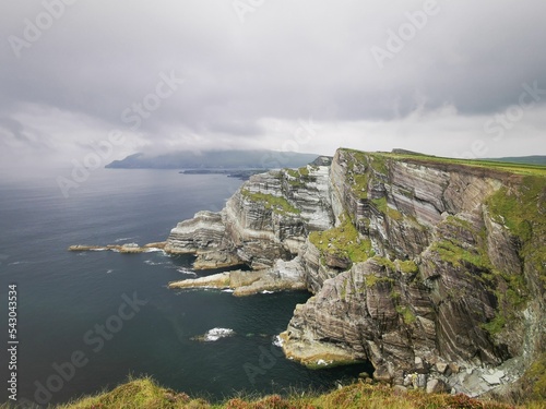 Kerry Cliffs (Aillte Chiarrai) in front of the ocean with a dramatic sky in the background, Ireland photo