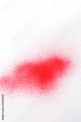 a red spray paint stain on a white paper background